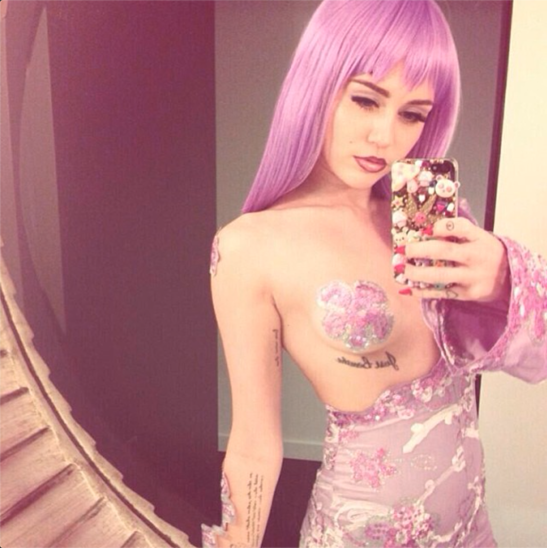 Miley Cyrus exposes her boob in rapper Lil Kim costume for Halloween