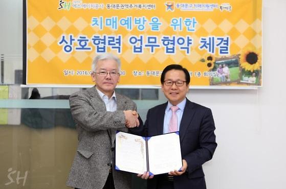 ▲송지영 치매지원센터장(왼쪽)과 김보곤 동대문주거복지센터장이 14일 치매 예방을 위한 상호협력 업무협약을 체결하고 기념 사진 촬영을 하고 있다. 사진=SH공사 제공
