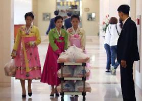 Separated families share lunch boxes during private meetings