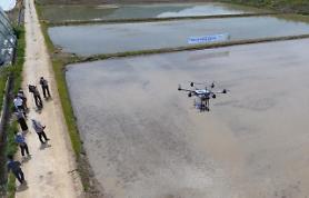 Agricultural research institute demonstrates rice seed-sowing drone