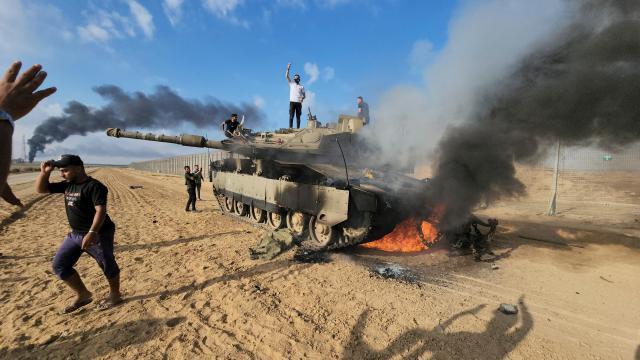 7일 가자지구 변방에서 팔레스타인 인들이 파괴된 이스라엘 탱크를 보고 기뻐하고 있다 사진AP 연합뉴스