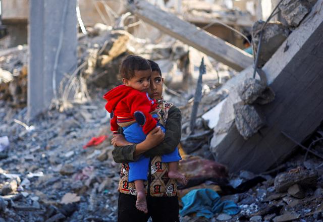 4일현지시간 가자지구 남부 라파의 이스라엘 공습 현장에서 한 팔레스타인 소년이 아기를 안고 있다 사진로이터 연합뉴스