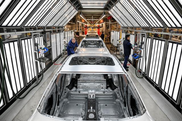 FILE PHOTO People work at the BMW Group plant in Munich Germany December 5 2023 REUTERS
