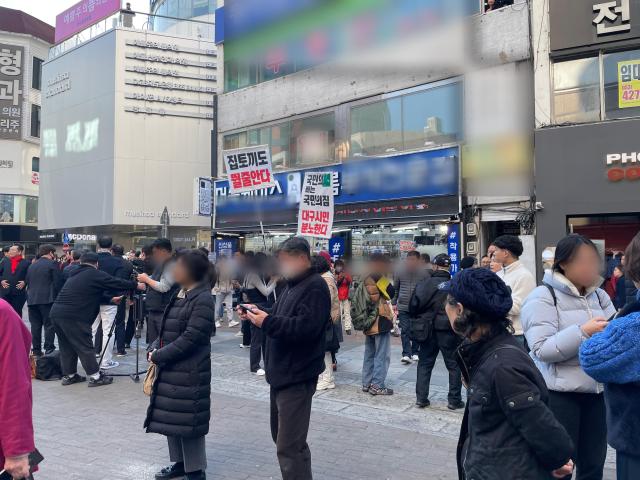 지난 21일 대구 동성로 젊음의 거리를 찾은 한동훈 국민의힘 총괄선대위원장이 거리 유세를 시작하자 '집토끼도 뛸줄 안다' 등 내용이 적힌 피켓을 든 시민들이 나타나 국민의힘 공천 결과에 항의하는 목소리를 냈다. [사진=김슬기 기자 ksg49@ajunews.com]