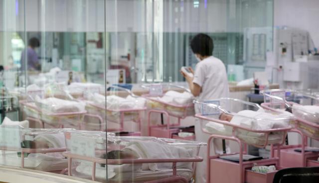 분기 출산율이 처음으로 06명대로 떨어지며 저출산 현상이 이어지고 있는 가운데 28일 오후 서울 시내 한 산후조리원 신생아실에서 한 관계자가 신생아를 돌보고 있다 사진연합뉴스 