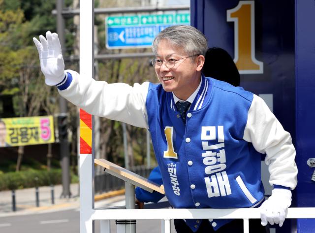 Min Hyung-bae a candidate of Democratic Party of Korea greets the crowd while campaigning on a vehicle on a street of Gwangsan-gu Gwangju April 9 2024 Yonhap