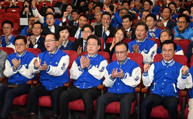 Members of the Democratic Party of Korea led by6 Leee Jae-myung send out a burst of clapping and cheer after joint exit poll results for South Koreas parliamentary elections were released on April 10 YONHAP PHOTO 