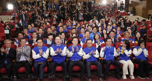 Members of the Democratic Party of Korea cheer after joint exit poll results for South Koreas parliamentary elections were released on April 10 YONHAP PHOTO