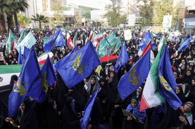 Iranians wave flags during a celebration following Irans missiles and drones attack on Israel at Palestine square in central Tehran on Monday AFP-Yonhap