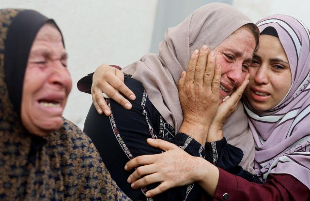 한 여성이 4월 21일현지시간 가자지구 남부 라파에서 이스라엘 공습으로 사망한 팔레스타인 주검들 옆에서 울부짓고 있다 사진로이터 연합뉴스 