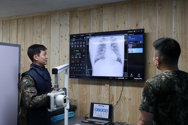 육군 51여단 의무중대 방사선실에서 AI 기반 휴대용 엑스레이 장비를 활용해 환자를 진료하고 있다 AI 기반 휴대용 엑스레이 장비는 의료영상 촬영 장비를 보유하지 않은 부대에서 활용 중이며 흉부질환 등 6개 질환에 대해 판독이 가능하다사진국방부