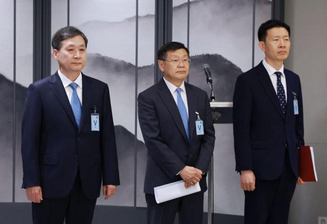 Yoon Young-bin left the nominee for the post of the inaugural chief of the Korea Aerospace Administration stands alongside nominees for other key posts John Lee center and Rho Kyung-won during a press briefing at the presidential office in Seoul on April 24 2024 Yonhap