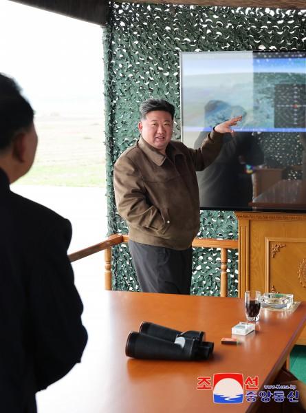 N. Korean leader inspects test-firing of new multiple rocket launcher shell