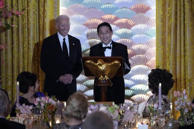 President Joe Biden left listens as Japanese Prime Minister Fumio Kishida speaks ahead of a toast during a state dinner at the White House in Washington on April 10 2024 AP-Yonhap