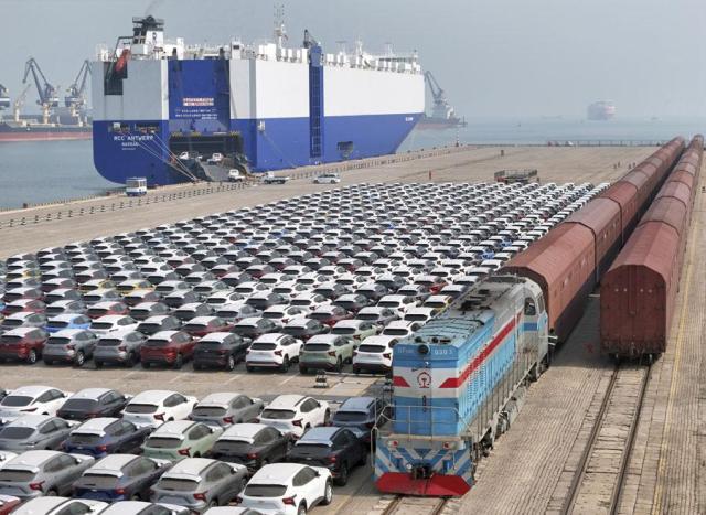 A freight train carrying cars to be exported arrives at a dock for ro-ro shipping in Yantai in eastern Chinas Shandong province on March 3 2024 AP-Yonhap
