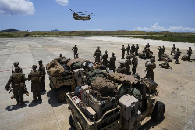 US and Philippine troopers prepare to board a US Army CH-47 helicopter at the airport at the Philippines northernmost town of Itbayat Batanes province during a joint military exercise on May 6 2024 AP-Yonhap
