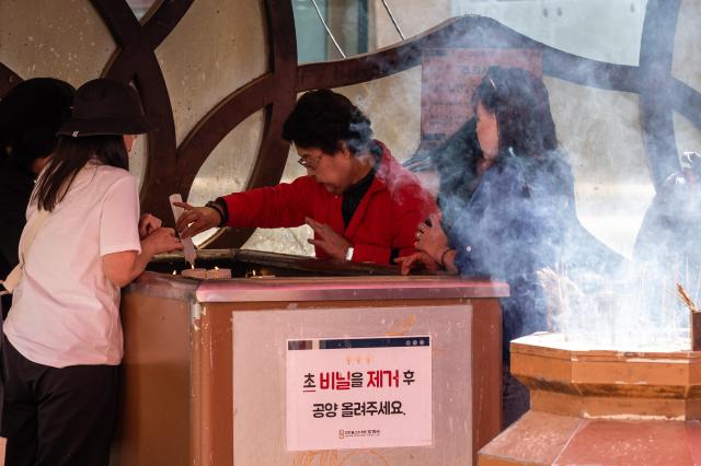 A visitor offers a candle at Jogyesa in Jongno Seoul May 8 2024 AJU PRESS Park Jong-hyeok