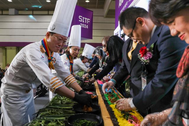 Participants from various countries join the K-Food GimBab ceremony during the kickoff of The 39th Seoul International Travel Fair at COEX in Seoul on May 9 2024AJU PRESS Kim Dong-woo