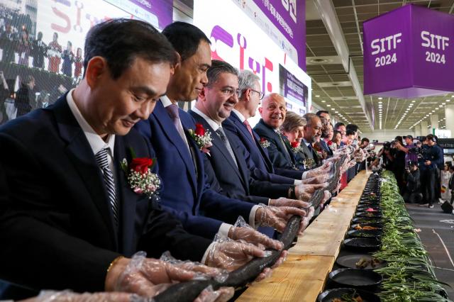 Participants from various countries join in the K-Food GimBab ceremony during the kickoff of The 39th Seoul International Travel Fair at COEX in Seoul on May 9 2024 AJU PRESS Kim Dong-woo
