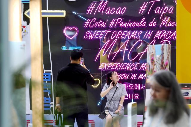 A visitor takes a photo at The ‘39th Seoul International Travel Fair’ at COEX in Seoul on May 9 2024 AJU PRESS Kim Dong-woo