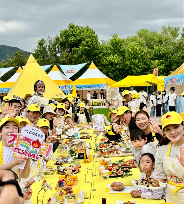Families pose for a photo at the Ottogi Sweet Home Family Cooking Festival in Seoul Land in Gwacheon on May 11 2024 AJU PRESS Han Jun-gu
