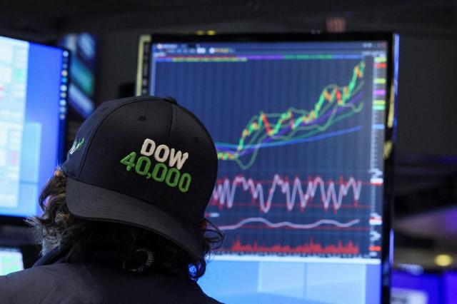 A trader wearing The Dow DJI hat works on the floor at the New York Stock Exchange NYSE in New York City on May 16 2024 Reuters-Yonhap