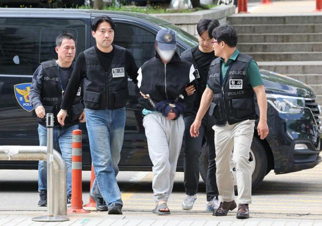 The suspect in a dating violence case arrives for questioning at the Seoul Prosecutors office in Seoul on May 8 2024  Yonhap
