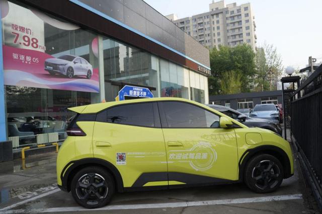 A Seagull electric vehicle from Chinese automaker BYD for test driving is parked outside a showroom in Beijing on April 10 2024 AP-Yonhap