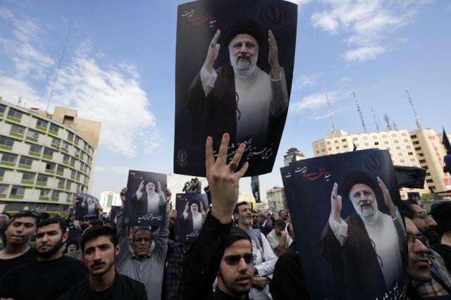 People hold up posters of Iranian President Ebrahim Raisi during a mourning ceremony for him at Vali-e-Asr square in downtown Tehran on May 20 2024 President Raisi and the countrys foreign minister were found dead Monday hours after their helicopter crashed in fog AP-Yonhap