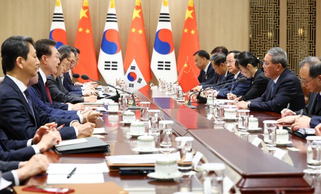 President Yoon Suk Yeol addresses the meeting with Chinese Premier Li Qiang at the Presidential Office in Yongsan Seoul on May 26 Joint Press Corps