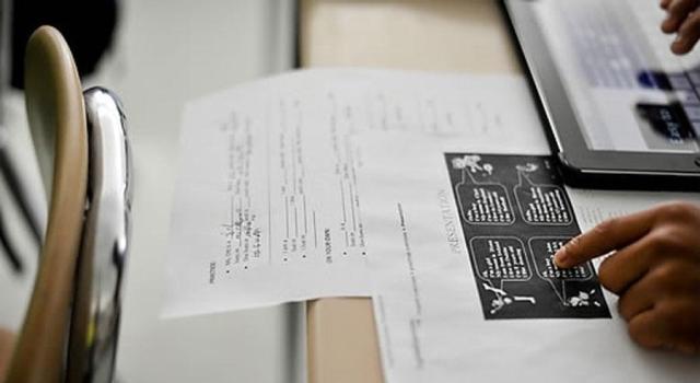 In this photo taken Sept 11 2014 a student in a class at the GW Career Educational Center in Frankford Delaware looks over a worksheet aimed at teaching basic introductions in English AP-Yonhap