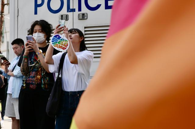 A participant takes photos at the 2024 Seoul Queer Culture Festival in central Seoul area on June 1 AJU PRESS Han Jun-gu