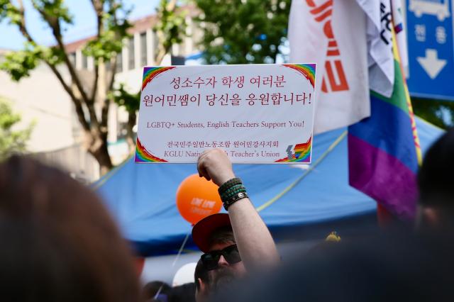 A participant holds a supportive sign for sexual minorities at the 2024 Seoul Queer Culture Festival in central Seoul area on June 1 AJU PRESS Han Jun-gu