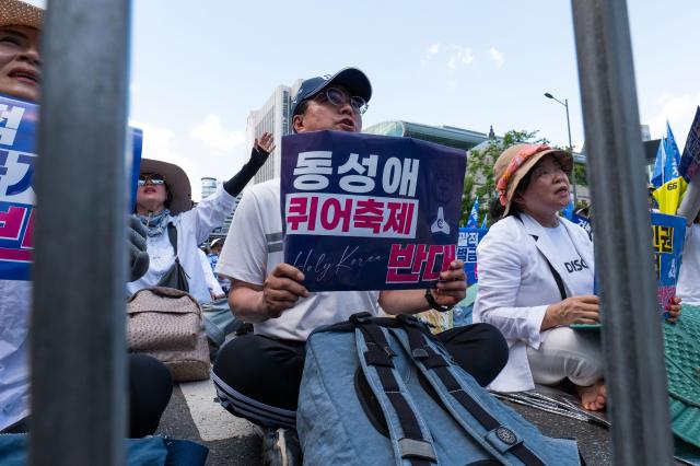 A participant holds a sign Oppose LGBTQ Festival and chants slogans near the city hall in Jung-gu Seoul on June 1 2024 AJU PRESS Park Jong-hyeok