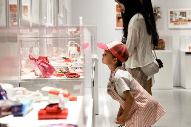 A child peers at an exhibit at the Hello Kitty 50th Anniversary Special Exhibition hold at the DDP on June 3 2024 AJU PRESS Han Jun-gu