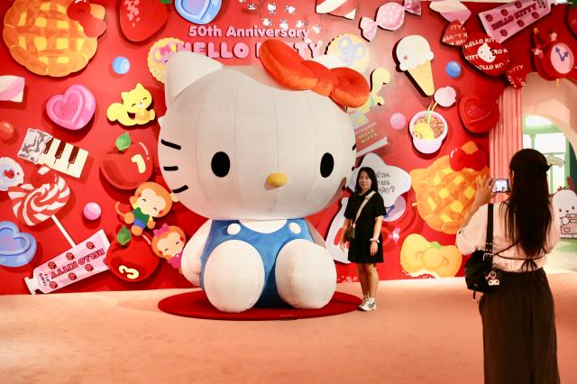 A visitor takes photo in front of a large Hello Kitty figure installed at the Hello Kitty 50th Anniversary Special Exhibition hold at the DDP on June 3 2024 AJU PRESS Han Jun-gu