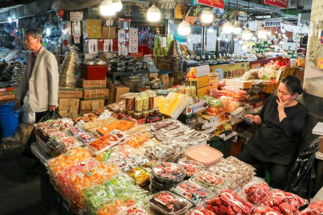 A citizen walks pass by a shop at a traditional market in Jongno-gu Seoul June 4 2024 AJU PRESS Kim Dong-woo