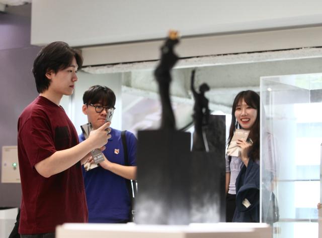 A visitor takes a photo of an exhibit at the Faker Temple in the HiKR Ground in central Seoul area on June 5th 2024 AJU PRESS Han Jun-gu
