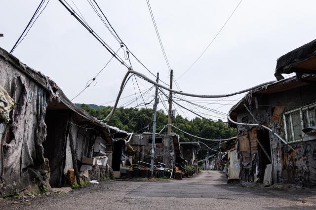 Inside the Guryong Village Gangnam Seoul on June 7 2024 The low height of the makeshift houses causes the power lines to hang down to nearly head level The village located in the affluent Gangnam is the last remaining slum in Seoul and is set to undergo redevelopment AJU PRESS Park Jong-hyeok