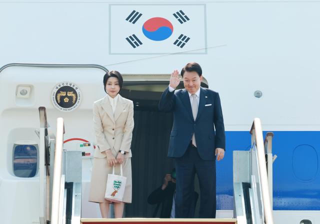 
President Yoon Suk Yeol and First Lady Kim Kun Hee is waving from a private jet as they embark on their official trip to three Central Asian countries Turkmenistan Kazakhstan and Uzbekistan Yonhap