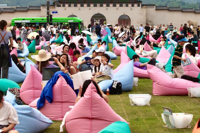 Visitors read and relax during the Seoul Outdoor Library event at Gwanghwamun Square in Seoul on June 7 2024 AJU PRESS Han Jun-gu