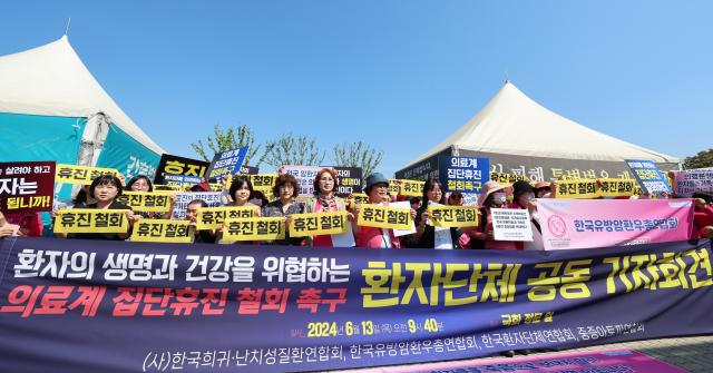 Các thành viên của Liên đoàn bệnh nhân Hàn Quốc tổ chức họp báo trước tòa nhà Quốc hội ở Yeouido Seoul vào sáng ngày 13 nhằm kêu gọi giới y tế rút lại quyết định nghỉ khám tập thể ẢnhYonhap News