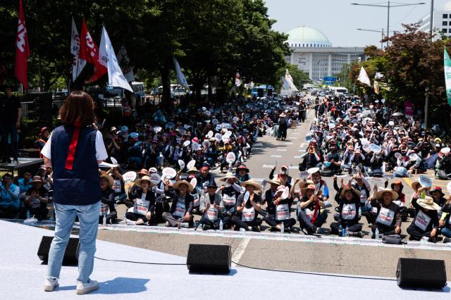 Cho Hang-ahleft the secretary general of the Korean Democratic Street Vendors Confederation hosts and moderates the 613 National Street Vendors Rally held in front of the Korea Development Bank in Yeongdeungpo district on June 13 2024 AJU PRESS Park Jong-hyeok