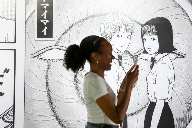 A visitor takes a photo at an exhibition in Mapo-gu Seoul June 17 2024 AJU PRESS Kim Dong-woo