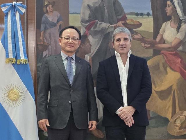  POSCO Holdings President Jeong Ki-seop left takes commemorative photo with Argentine Economy Minister Luis Caputo in Buenos Aires Argentina following discussions on their lithium business cooperation on June 12 2024 Courtesy of POSCO