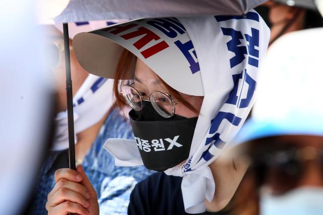 A participant wears a mask that reads Increase medical school enrollment X at a rally Yeouido Seoul South Korea June 18 2024 AJU PRESS Kim Dong-woo