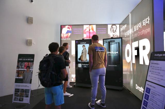 Visitors experience the AI Lookbook Photoshoot booth at DDP Showroom on June 10 2024 AJU PRESS Han Jun-gu