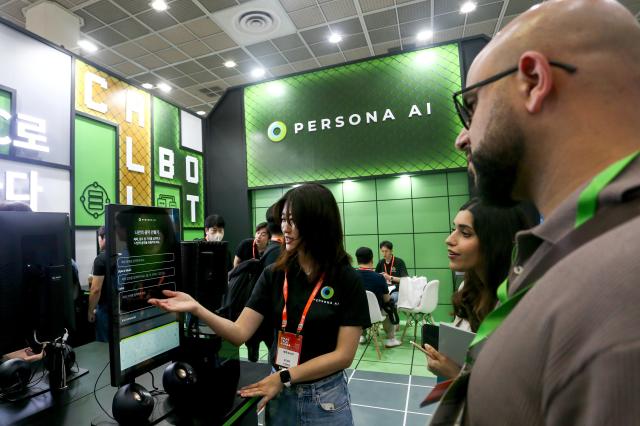 Visitors listen to a booth representative at SmartTech Korea at COEX in Seoul on June 19 2024 AJU PRESS Kim Dong-woo