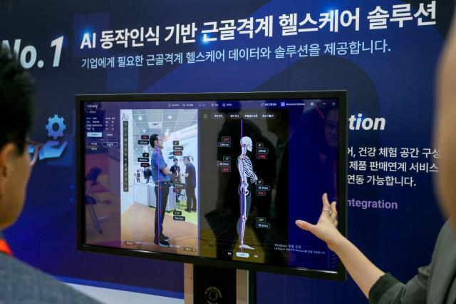 Visitors listen to a booth representative at SmartTech Korea on June 19 2024 at COEX in Seoul AJU PRESS Kim Dong-woo