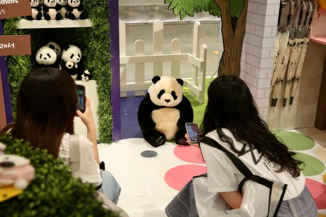 Visitors take pictures of goods at the Bao Family Pop-up Store Season 2 held at The Hyundai Seoul on June 20 2024 AJU PRESS Han Jun-gu